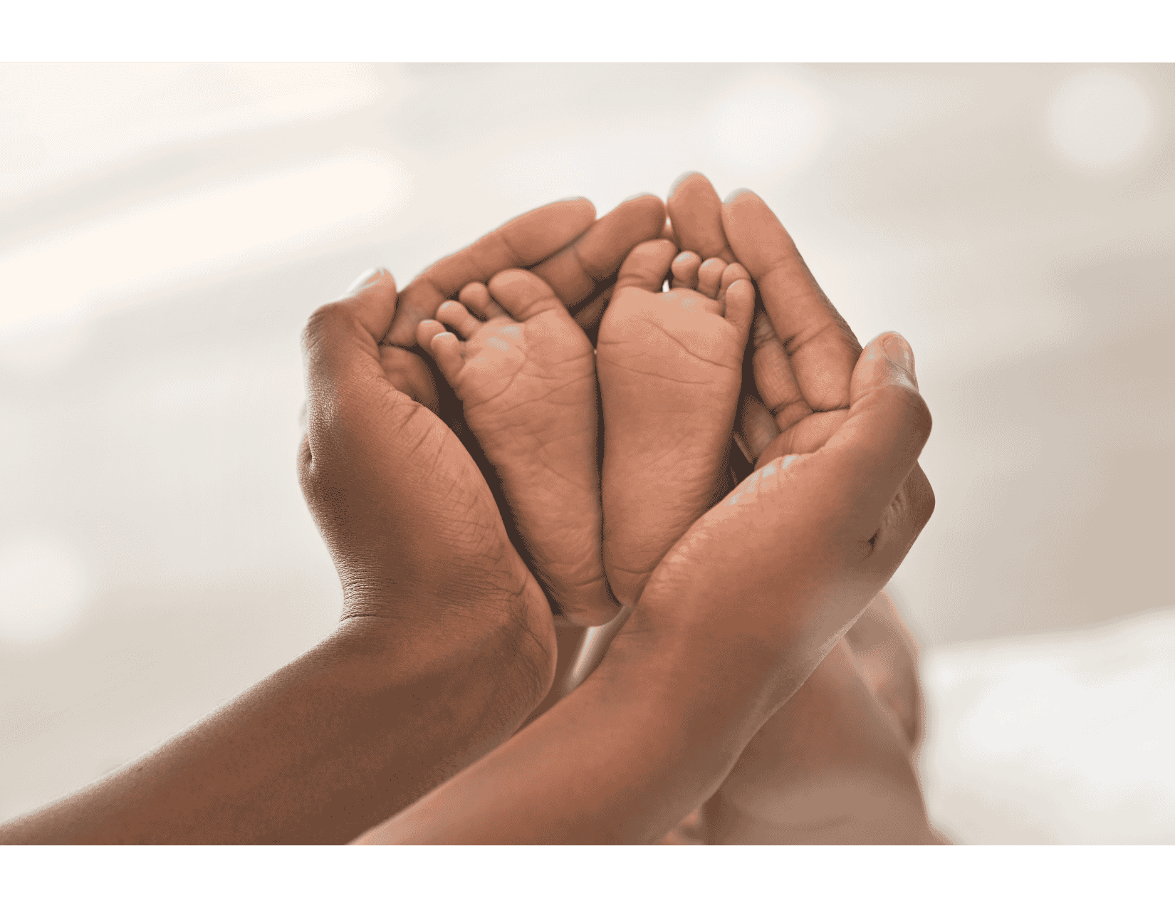 Parent hands cradling newborn feet, illustrating support available through the Ontario fertility tax credit.